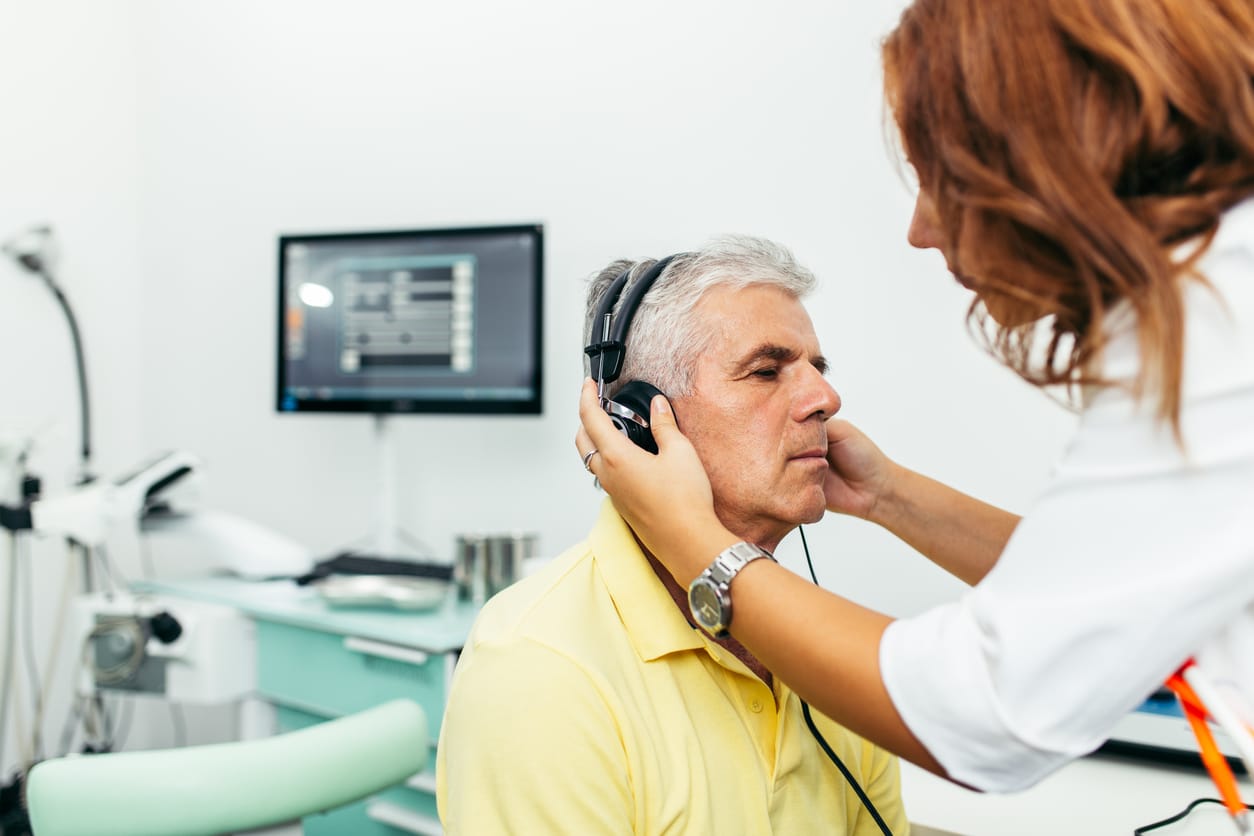 Man having his hearing tested at the audiologist.