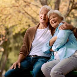 Happy couple on a bench enjoying the weather